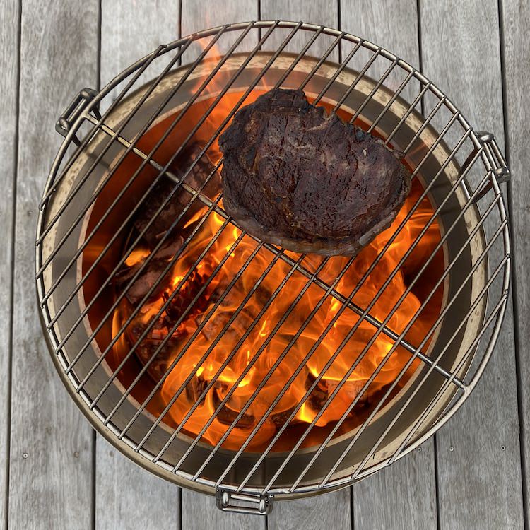 Grill top for outlet fire pit